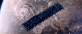 a spaceship is floating over earth and the photo is taken from a birds eye view.